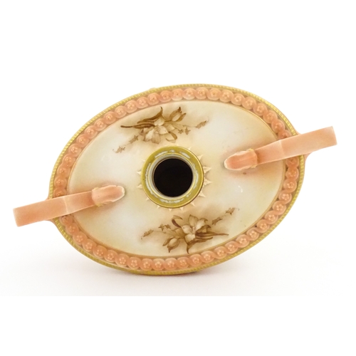 114 - A Hadley's Worcester twin handled squat vase of boat form with floral and foliate decoration. Marked... 