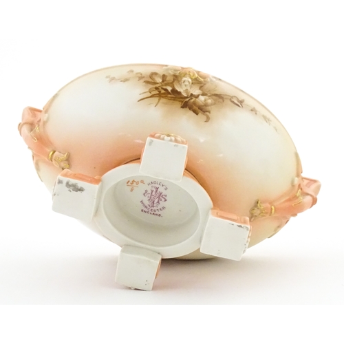 114 - A Hadley's Worcester twin handled squat vase of boat form with floral and foliate decoration. Marked... 