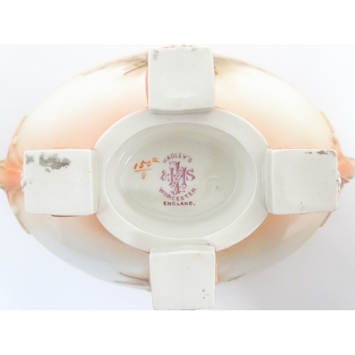 114 - A Hadley's Worcester twin handled squat vase of boat form with floral and foliate decoration. Marked... 