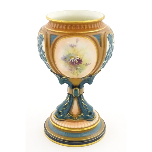 115 - A Hadley's Worcester pedestal vase of goblet form decorated with wild flowers. Marked under and numb... 
