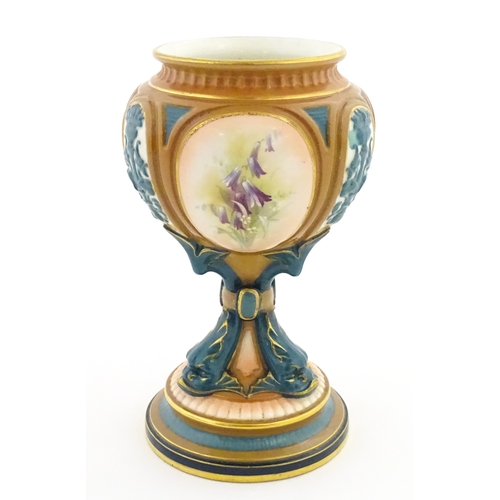 115 - A Hadley's Worcester pedestal vase of goblet form decorated with wild flowers. Marked under and numb... 