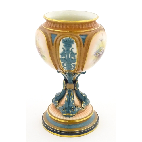 115 - A Hadley's Worcester pedestal vase of goblet form decorated with wild flowers. Marked under and numb... 