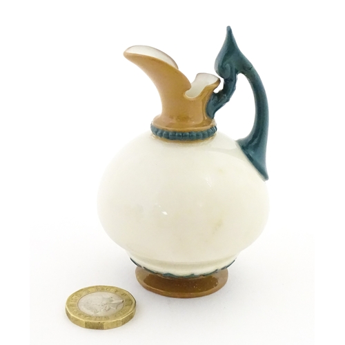 116 - A small Hadley's Worcester jug with shaped handle. Marked under. Approx. 3 1/2