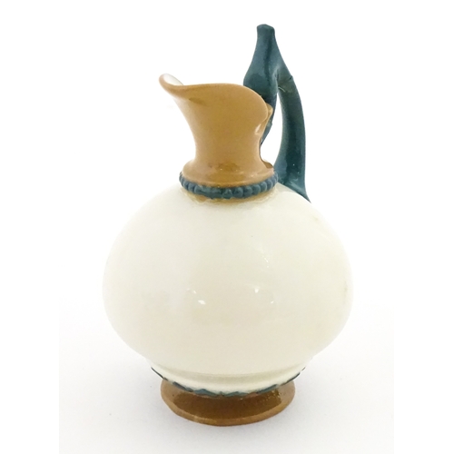 116 - A small Hadley's Worcester jug with shaped handle. Marked under. Approx. 3 1/2