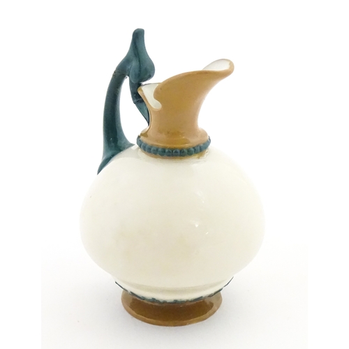 116 - A small Hadley's Worcester jug with shaped handle. Marked under. Approx. 3 1/2