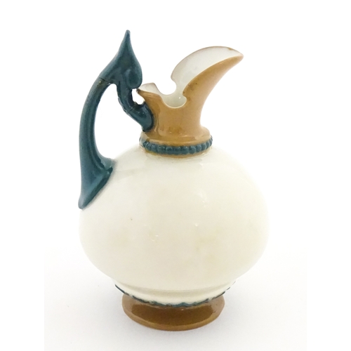 116 - A small Hadley's Worcester jug with shaped handle. Marked under. Approx. 3 1/2
