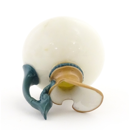 116 - A small Hadley's Worcester jug with shaped handle. Marked under. Approx. 3 1/2