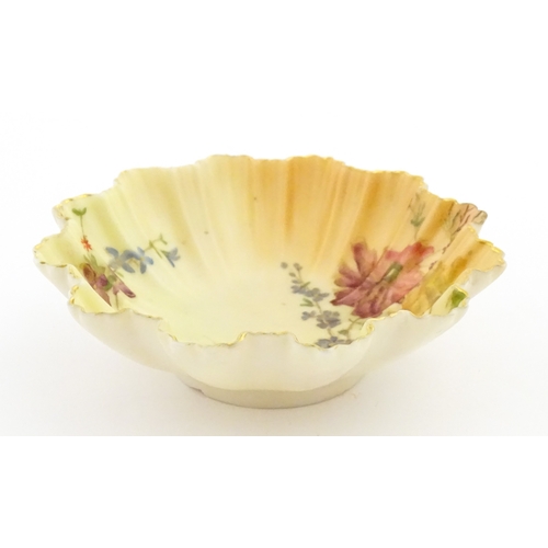 117 - A Royal Worcester blush ivory dish of frilled shell form decorated with flowers. Marked under and nu... 
