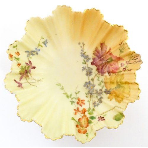117 - A Royal Worcester blush ivory dish of frilled shell form decorated with flowers. Marked under and nu... 