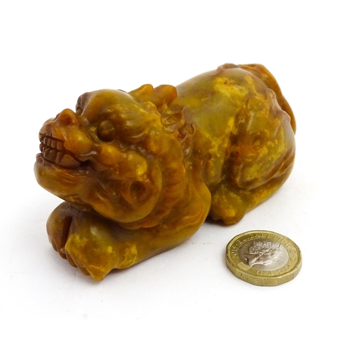 1036 - A Chinese soapstone model of a Guardian lion / Foo Dog. Approx. 3 3/4