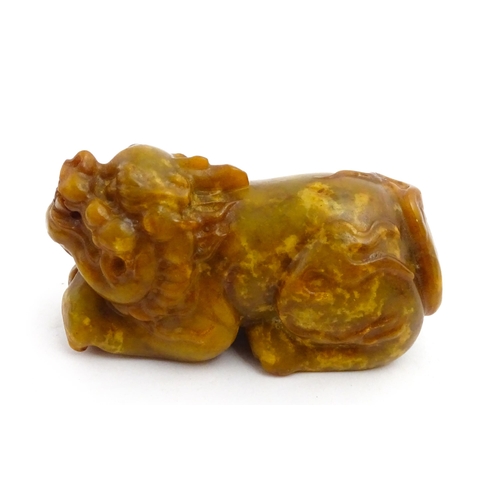 1036 - A Chinese soapstone model of a Guardian lion / Foo Dog. Approx. 3 3/4