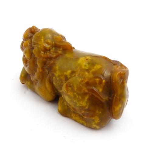 1036 - A Chinese soapstone model of a Guardian lion / Foo Dog. Approx. 3 3/4