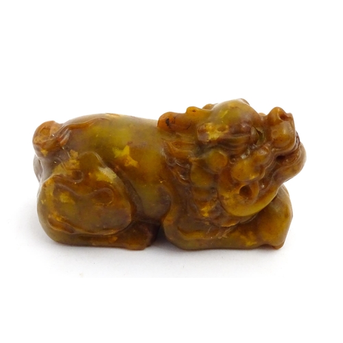 1036 - A Chinese soapstone model of a Guardian lion / Foo Dog. Approx. 3 3/4