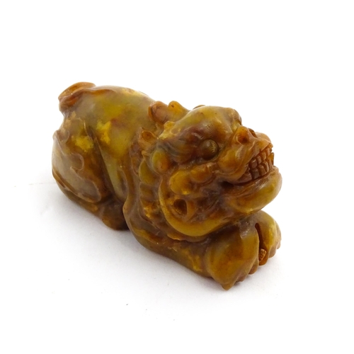 1036 - A Chinese soapstone model of a Guardian lion / Foo Dog. Approx. 3 3/4
