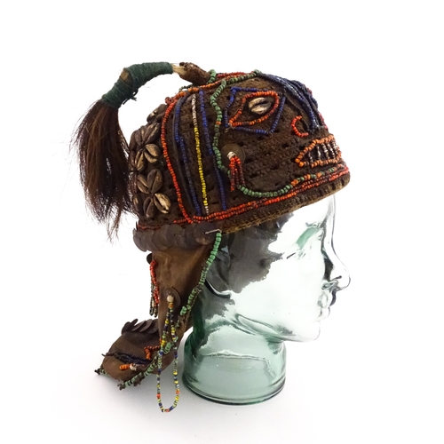 1169 - Ethnographic / Native / Tribal : A tribal headdress / hat with beadwork and cowrie shell decoration ... 