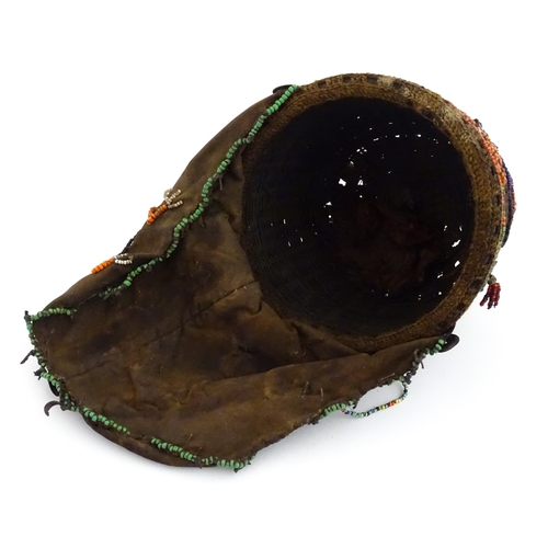 1169 - Ethnographic / Native / Tribal : A tribal headdress / hat with beadwork and cowrie shell decoration ... 