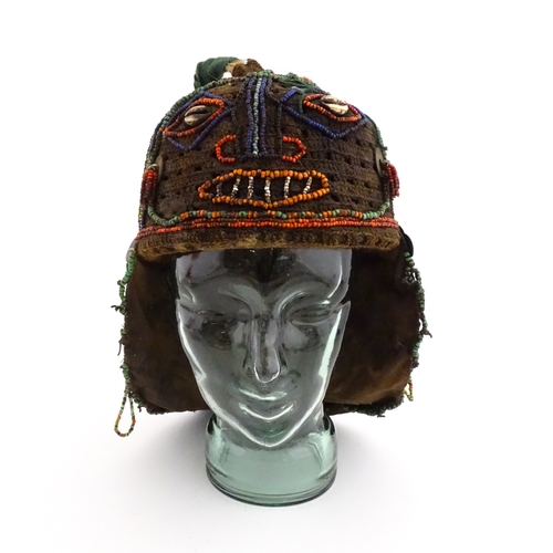 1169 - Ethnographic / Native / Tribal : A tribal headdress / hat with beadwork and cowrie shell decoration ... 