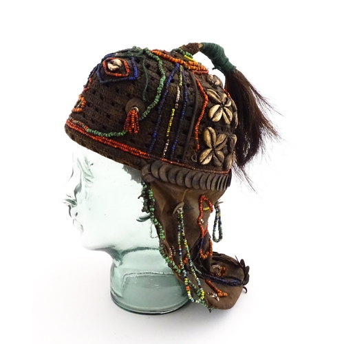 1169 - Ethnographic / Native / Tribal : A tribal headdress / hat with beadwork and cowrie shell decoration ... 