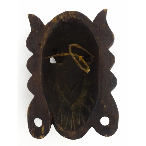 1170 - Ethnographic / Native / Tribal : Two African carved wooden masks, both with teeth bared and tongue o... 