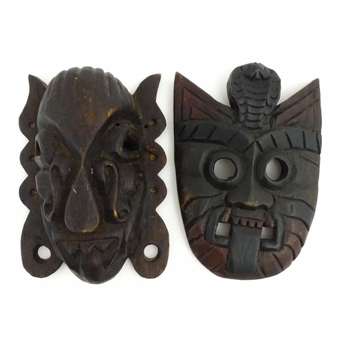1170 - Ethnographic / Native / Tribal : Two African carved wooden masks, both with teeth bared and tongue o... 