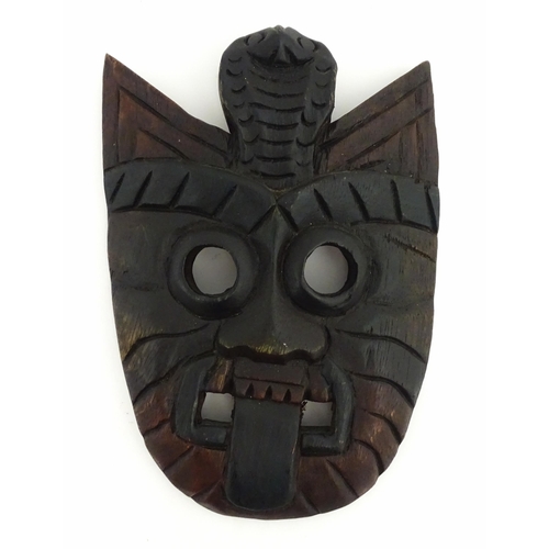 1170 - Ethnographic / Native / Tribal : Two African carved wooden masks, both with teeth bared and tongue o... 