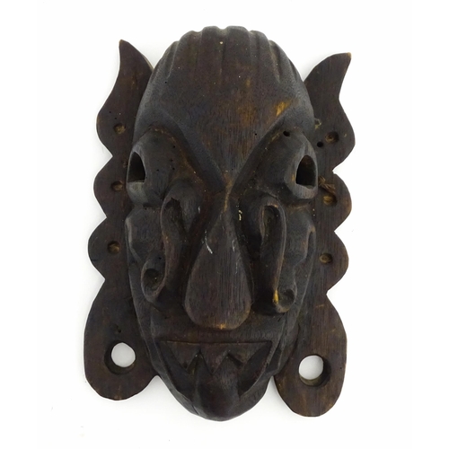 1170 - Ethnographic / Native / Tribal : Two African carved wooden masks, both with teeth bared and tongue o... 