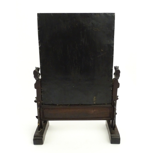 1262 - A Chinese table screen with cast green painted panel having relief decoration depicting an Imperial ... 