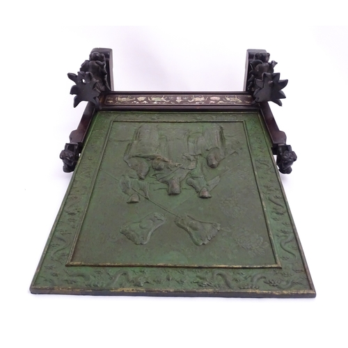 1262 - A Chinese table screen with cast green painted panel having relief decoration depicting an Imperial ... 