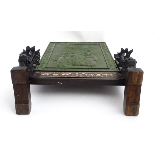 1262 - A Chinese table screen with cast green painted panel having relief decoration depicting an Imperial ... 