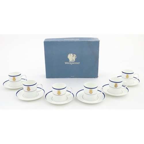194 - A set of six Wedgwood coffee cups and saucers with gilt Harrow School crest detail. Box approx. 12 3... 