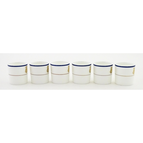 194 - A set of six Wedgwood coffee cups and saucers with gilt Harrow School crest detail. Box approx. 12 3... 