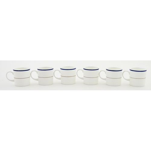 194 - A set of six Wedgwood coffee cups and saucers with gilt Harrow School crest detail. Box approx. 12 3... 