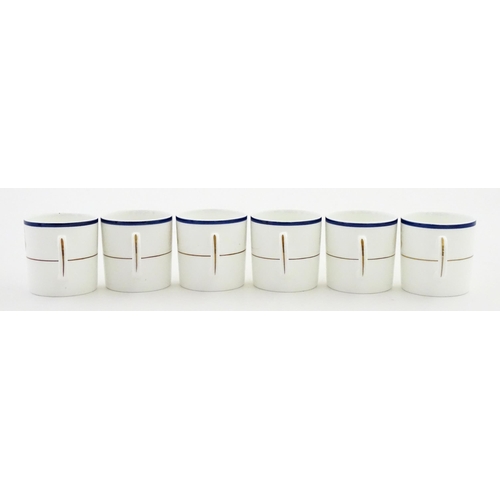 194 - A set of six Wedgwood coffee cups and saucers with gilt Harrow School crest detail. Box approx. 12 3... 