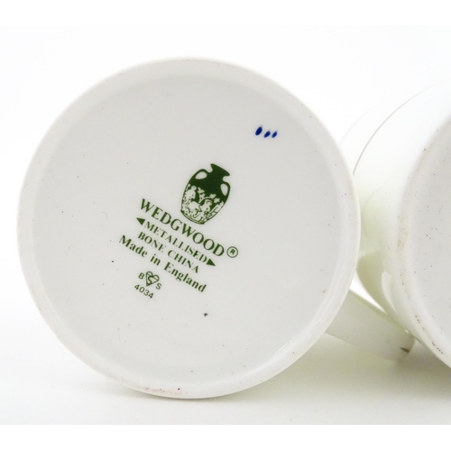 194 - A set of six Wedgwood coffee cups and saucers with gilt Harrow School crest detail. Box approx. 12 3... 