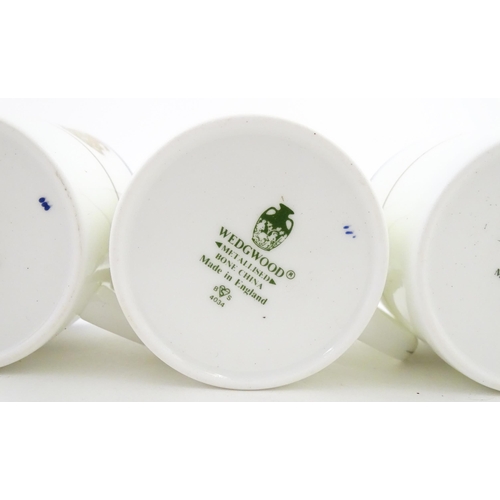 194 - A set of six Wedgwood coffee cups and saucers with gilt Harrow School crest detail. Box approx. 12 3... 