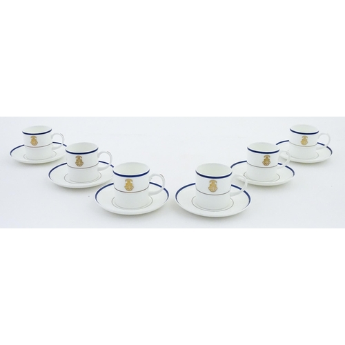 194 - A set of six Wedgwood coffee cups and saucers with gilt Harrow School crest detail. Box approx. 12 3... 