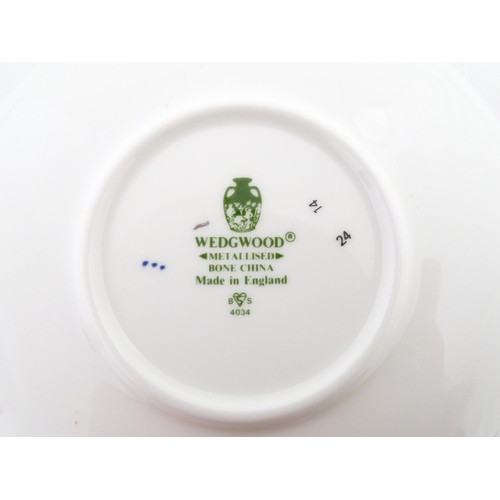 194 - A set of six Wedgwood coffee cups and saucers with gilt Harrow School crest detail. Box approx. 12 3... 