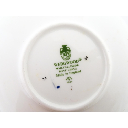 194 - A set of six Wedgwood coffee cups and saucers with gilt Harrow School crest detail. Box approx. 12 3... 