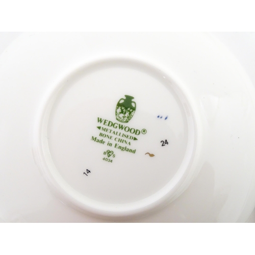 194 - A set of six Wedgwood coffee cups and saucers with gilt Harrow School crest detail. Box approx. 12 3... 