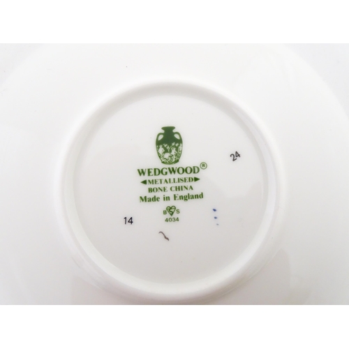 194 - A set of six Wedgwood coffee cups and saucers with gilt Harrow School crest detail. Box approx. 12 3... 