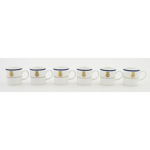 194 - A set of six Wedgwood coffee cups and saucers with gilt Harrow School crest detail. Box approx. 12 3... 