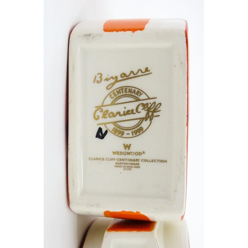 203 - A Wedgwood Clarice Cliff Centenary Stamford teapot, sugar bowl and cream jug in the Melon pattern, a... 