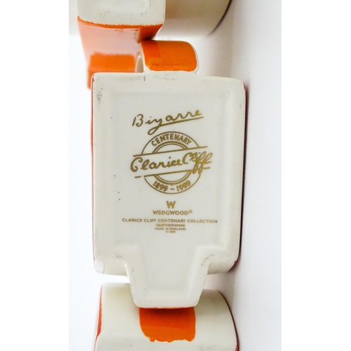 203 - A Wedgwood Clarice Cliff Centenary Stamford teapot, sugar bowl and cream jug in the Melon pattern, a... 