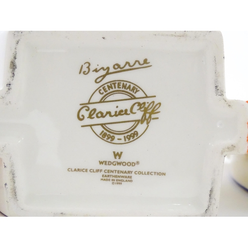 203 - A Wedgwood Clarice Cliff Centenary Stamford teapot, sugar bowl and cream jug in the Melon pattern, a... 