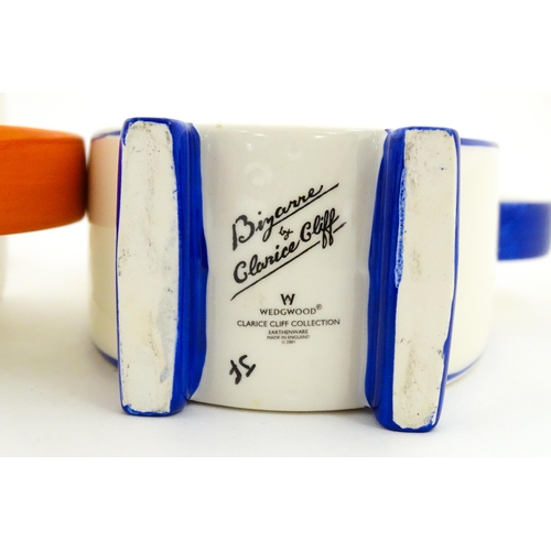 203 - A Wedgwood Clarice Cliff Centenary Stamford teapot, sugar bowl and cream jug in the Melon pattern, a... 