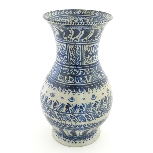 208 - A Continental blue and  white vase with flared rim having banded foliate decoration. Approx. 12