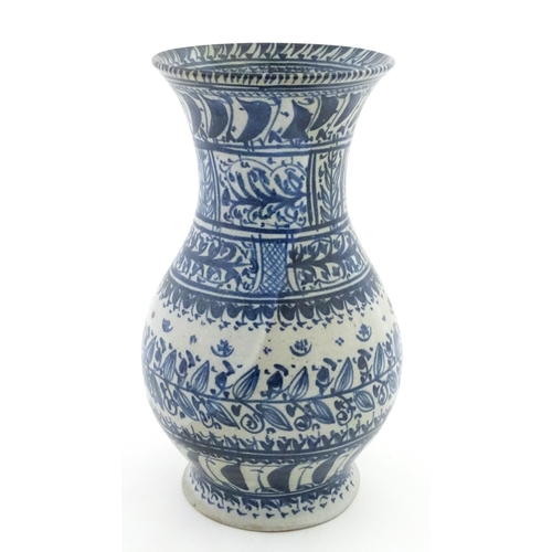 208 - A Continental blue and  white vase with flared rim having banded foliate decoration. Approx. 12