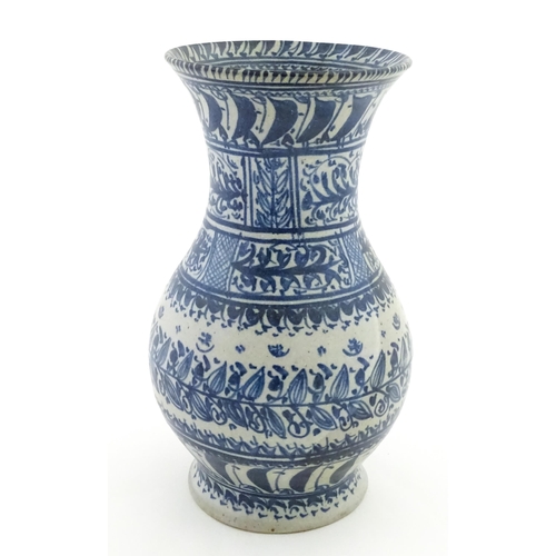 208 - A Continental blue and  white vase with flared rim having banded foliate decoration. Approx. 12
