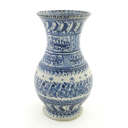 208 - A Continental blue and  white vase with flared rim having banded foliate decoration. Approx. 12