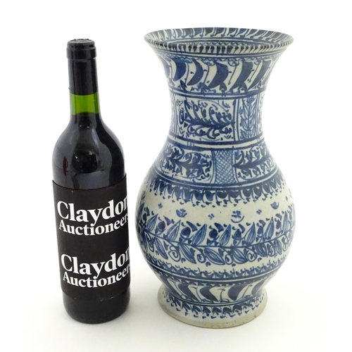 208 - A Continental blue and  white vase with flared rim having banded foliate decoration. Approx. 12